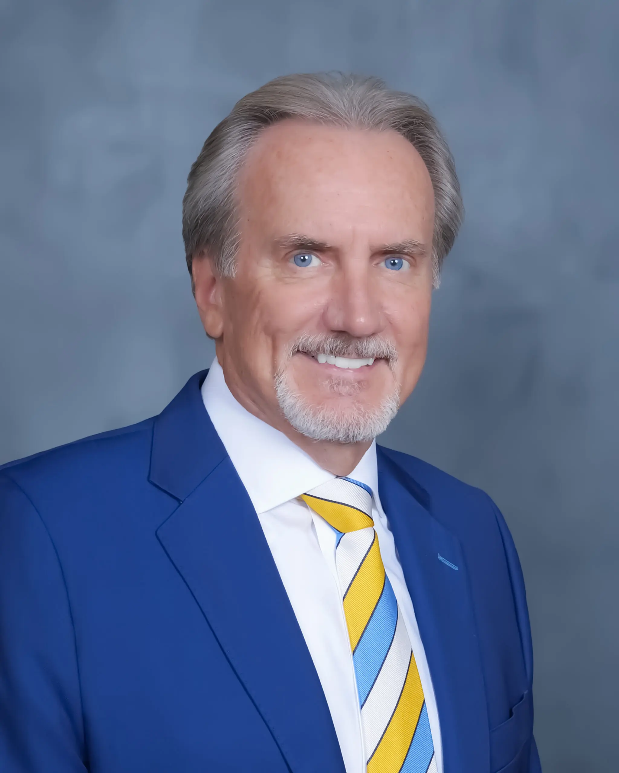 Professional man in blue suit with striped tie.