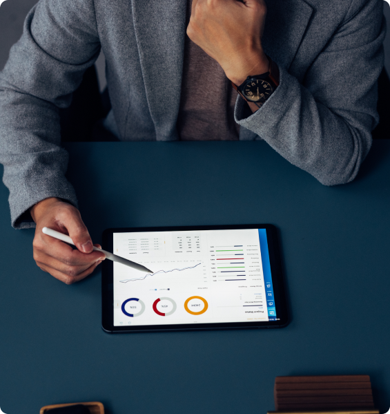 Person analyzing data on a tablet screen.