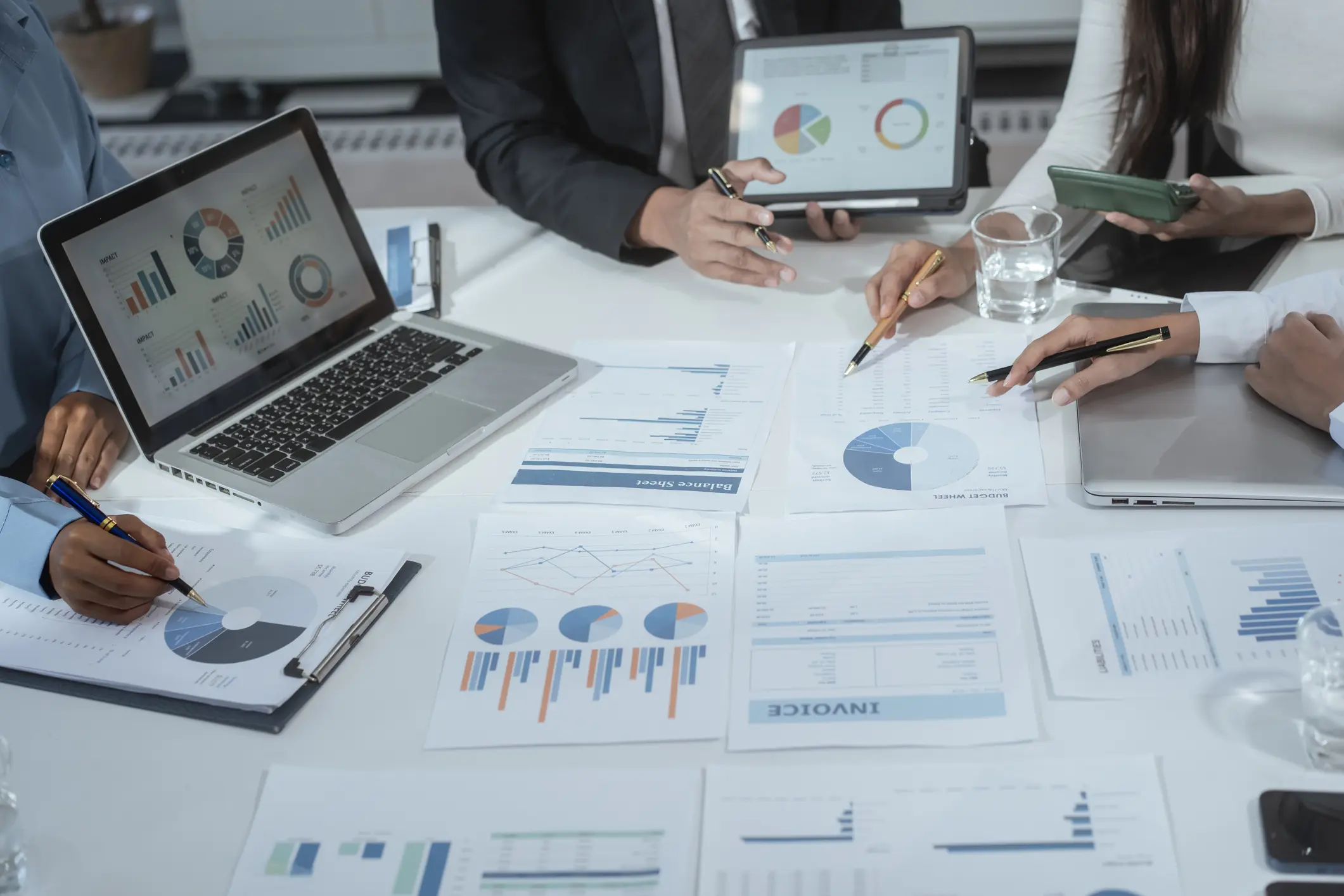 Business team analyzing charts and graphs.