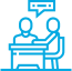 Two people talking at a desk icon.